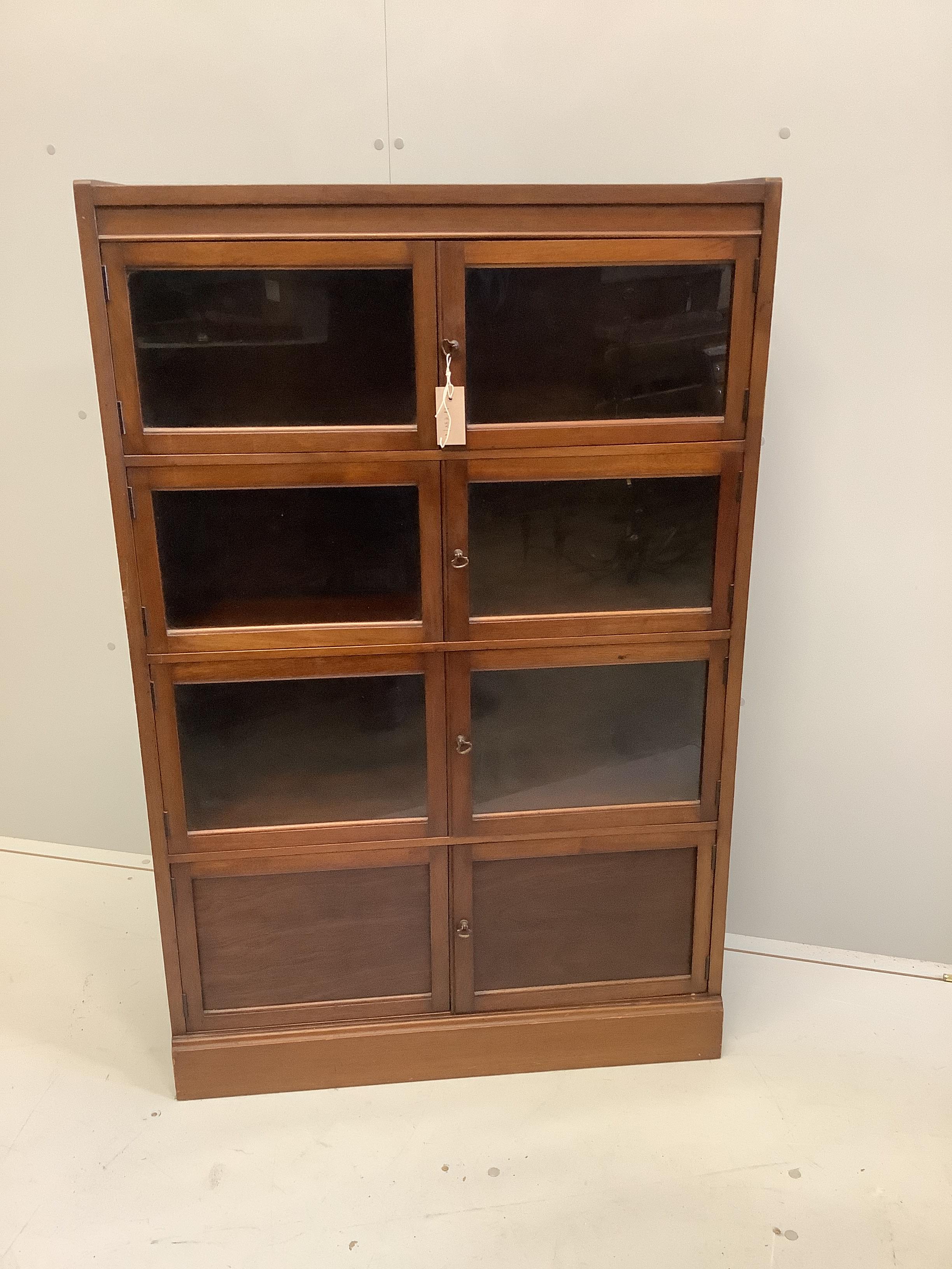 An early 20th century glazed mahogany bookcase, width 81cm, depth 27cm, height 126cm